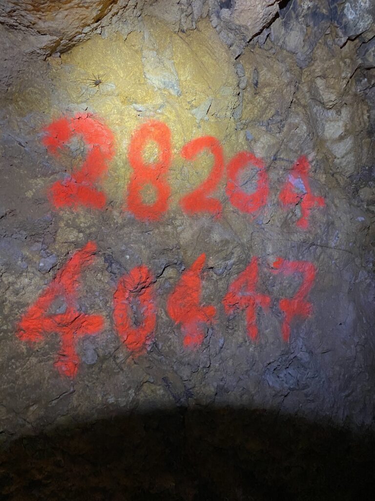 Red numbers on rock.
